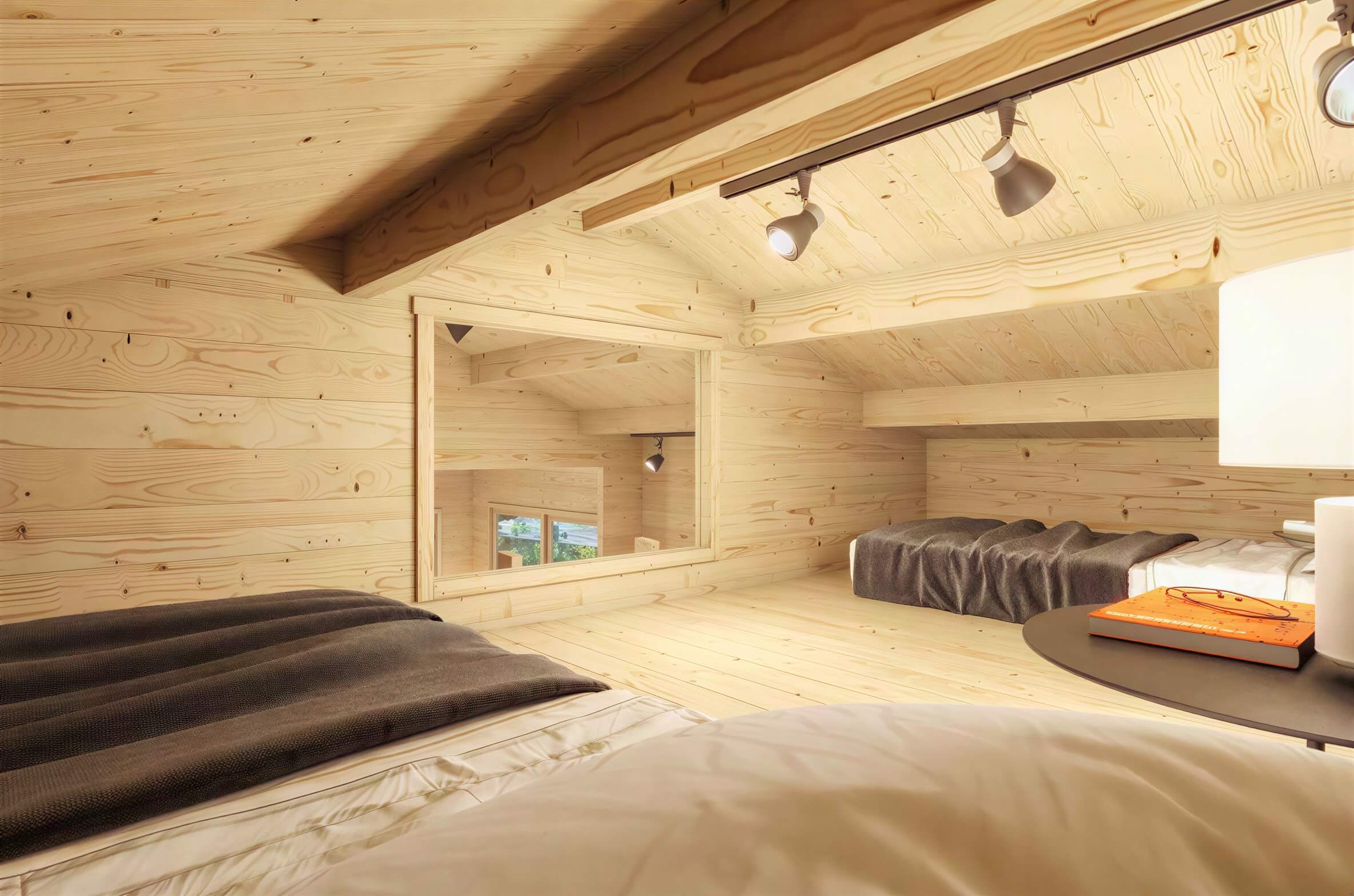 Loft view of the Sawmill Structures Edwin Lake House PLUS 70MM Garden Room reveals multiple sleeping spots under track lights and a wide interior window overlooking the main room