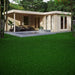 GardenHouse24 USA Luisa 70 Garden Room appears furnished with black outdoor seating and greenery, blending into a lush garden setting