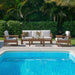 LuxCraft Lanai Deep Seating Set - Sofa, Loveseat, And Corner Unit offers a cozy poolside arrangement, including a sofa, armchairs, and a coffee table with neutral beige cushions