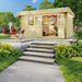 With open doors and visible indoor decor, the GardenHouse24 USA Miriam 44A Classic Garden Room appears warm and inviting in a landscaped backyard