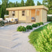 GardenHouse24 USA Miriam 44C Classic Garden Room is pictured with an inviting outdoor patio and open double doors leading inside