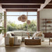 Modern living room features Crate & Barrel Steppe 68" Walnut Storage Bookcase Room Divider behind a sofa as a stylish room divider and storage piece