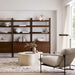 Modern living room featuring multiple Crate & Barrel Tate 36" Walnut Wood 3-Shelf Storage Bookcase Cabinet units styled with decorative objects and books