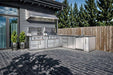 Modern patio setup with stainless steel grills and cabinets featuring the Sunstone Texas Tango 19ft Outdoor Kitchen Island Package