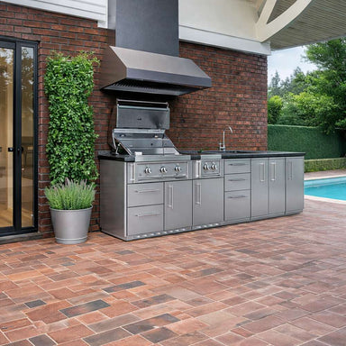 Modern patio setup with the Sunstone Magnolia 10ft Outdoor Kitchen Island Package featuring a grill, sink, and storage