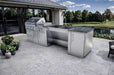 Modern patio view of the Sunstone Summit 10ft Outdoor Kitchen Island Package with grill, sink, and storage beside a peaceful lake