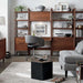 Modern workspace furnished with multiple walnut storage pieces, including the Crate & Barrel Tate Walnut Bookcase File Cabinet, arranged around a compact desk
