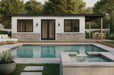 Modern Sawmill Structures The Tremblant Garden Suites with white siding, stone base, and black-trimmed windows stands behind a serene pool and spa