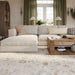Modern sectional sofa and coffee table rest on Momeni Anatolia Indoor Rug - ANA-5 Beige