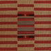 Momeni Adobe Indoor Rug - ADO-1 Red displays a bold center design with layered stripes in red, tan, and black
