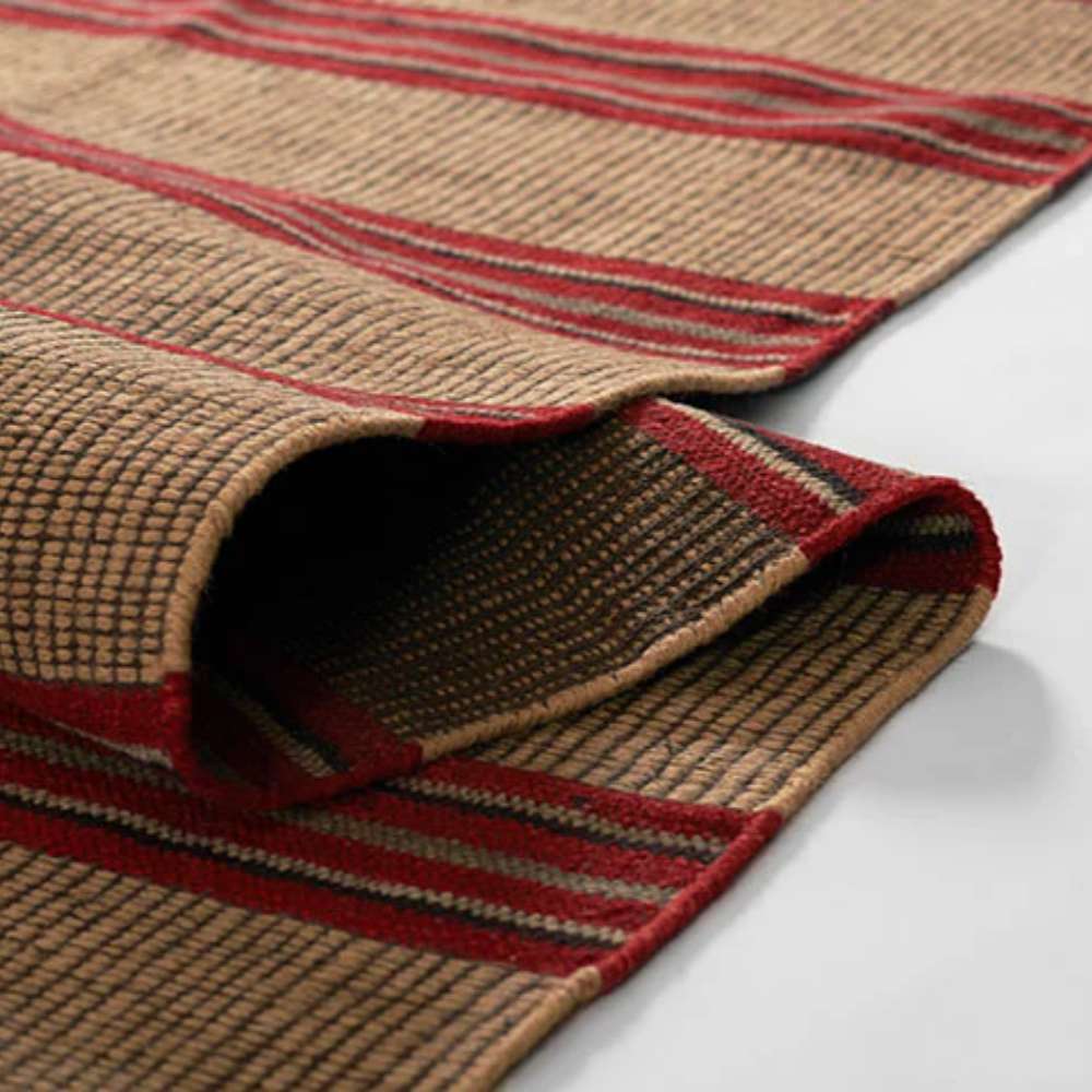Momeni Adobe Indoor Rug - ADO-1 Red is shown rolled at the edge