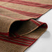 Momeni Adobe Indoor Rug - ADO-1 Red is shown rolled at the edge