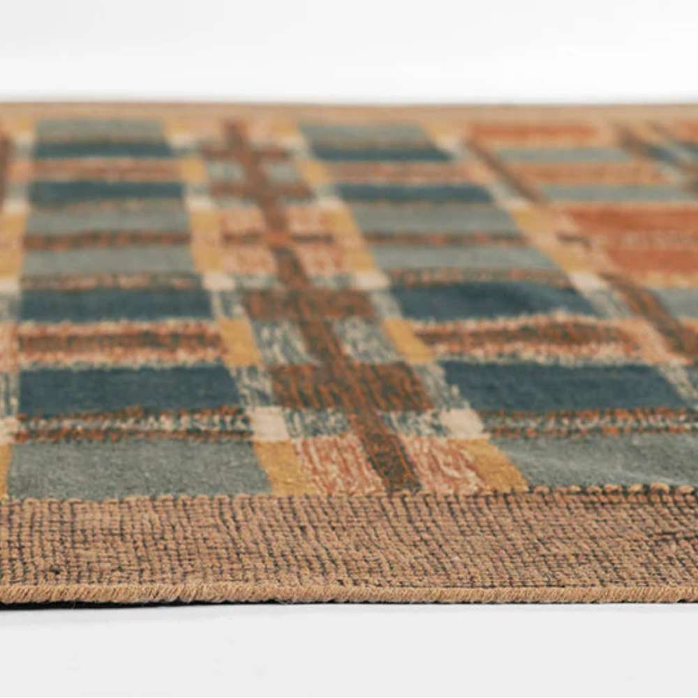 Momeni Adobe Indoor Rug - ADO-3 Blue features a plaid grid pattern in warm orange, blue, and neutral shades