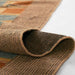 Momeni Adobe Indoor Rug - ADO-3 Blue shows its flexibility as it is partially folded revealing a sturdy backing