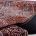 Momeni Afshar Indoor Rug - AFS36 Copper is folded to showcase its flexibility and finely stitched edges
