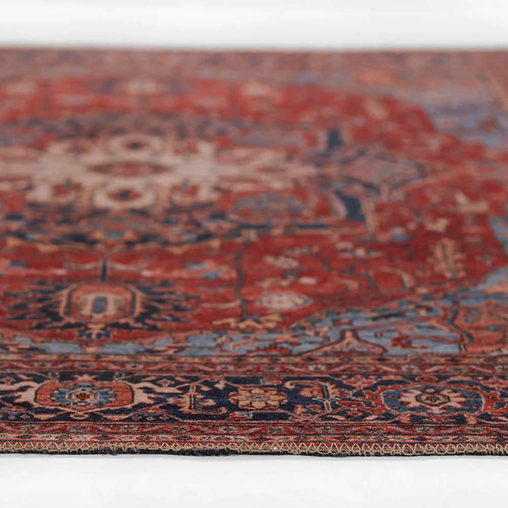 Momeni Afshar Indoor Rug - AFS37 Red is shown from a side view emphasizing its low-pile height and smooth finish