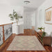 Momeni Anatolia Indoor Rug - ANA-10 Pink placed in a hallway with wood floors