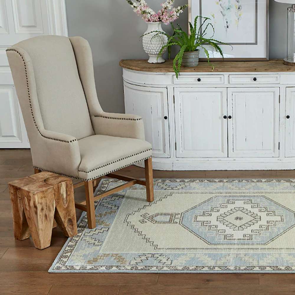 Momeni Anatolia Indoor Rug - ANA-2 Light Blue styled in a cozy living space with a chair and console table