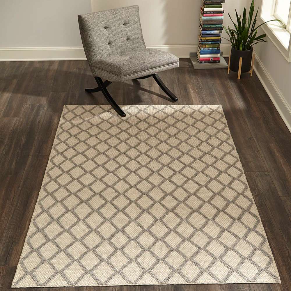 Momeni Andes Indoor Rug - AND-7 Natural is styled in a modern living room with a gray chair and wood floors