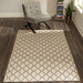 Momeni Andes Indoor Rug - AND-7 Natural is styled in a modern living room with a gray chair and wood floors
