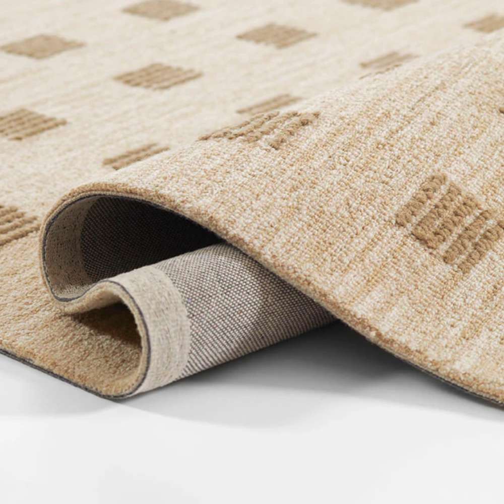 Momeni Archer Indoor Rug - ARC-1 Beige is flexible and durable shown rolled at the edges