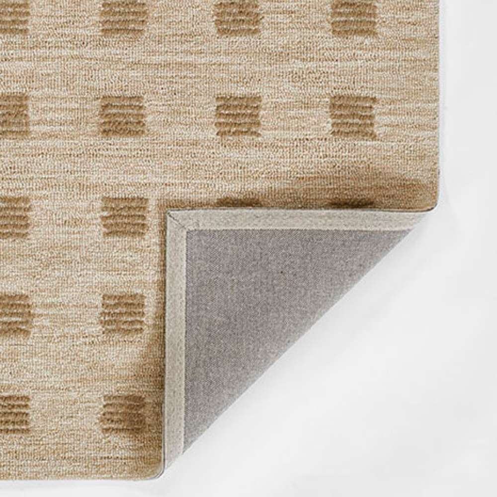 Momeni Archer Indoor Rug - ARC-1 Beige showcases its corner fold with a durable backing