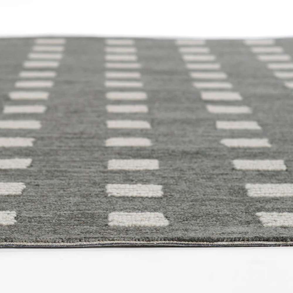 Momeni Archer Indoor Rug - ARC-1 Charcoal features evenly spaced rows of white patterned squares on a dark grey background