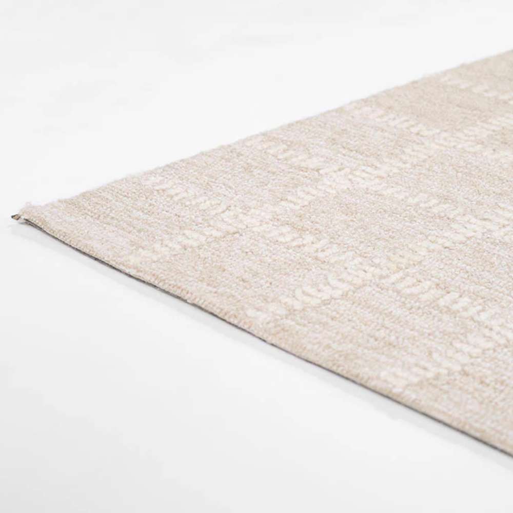 Momeni Archer Indoor Rug - ARC-3 Beige lies flat on the floor showcasing its smooth, low-pile surface