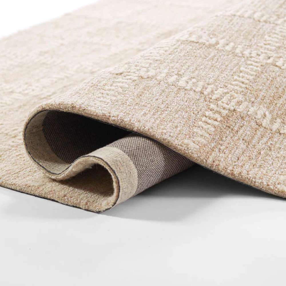 Momeni Archer Indoor Rug - ARC-3 Beige rolls smoothly, showing flexibility and strength in its premium weave