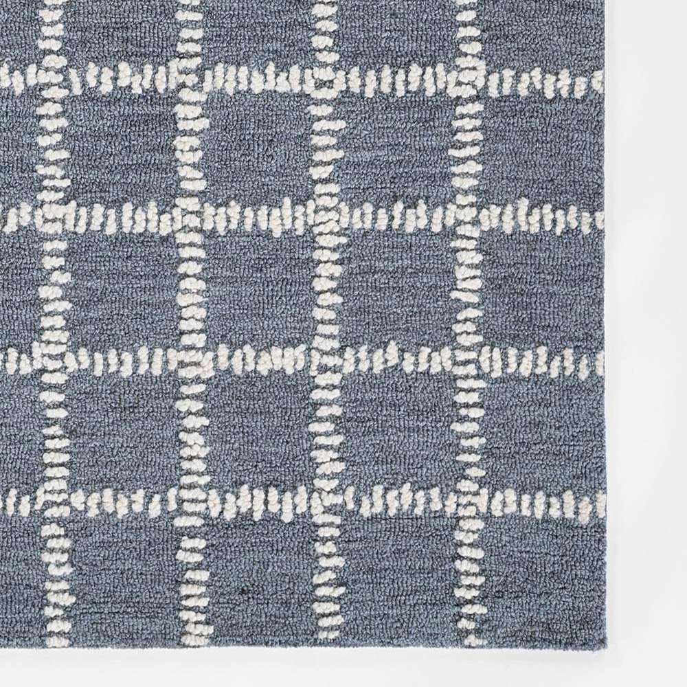 Momeni Archer Indoor Rug - ARC-3 Blue features a soft blue background with an ivory stitched grid pattern