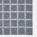 Momeni Archer Indoor Rug - ARC-3 Blue features a soft blue background with an ivory stitched grid pattern