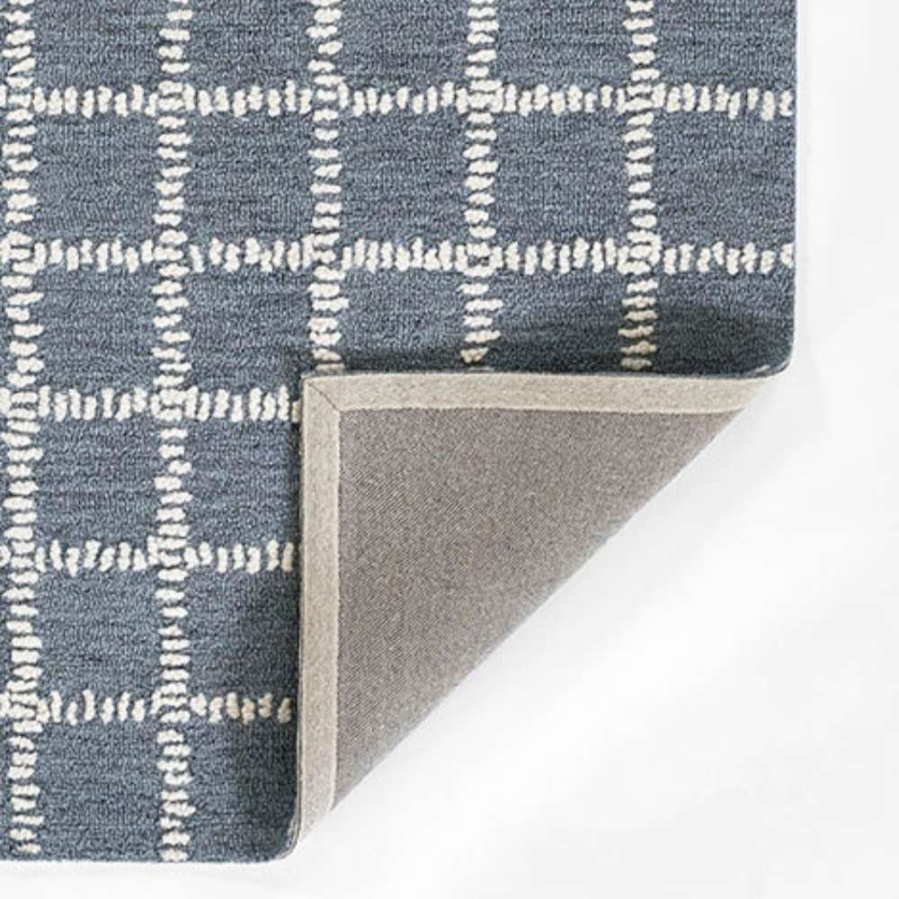 Momeni Archer Indoor Rug - ARC-3 Blue is shown from the corner, highlighting its sturdy backing and neat edge finish