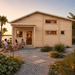 Montreal 70 transformed into an upscale golden-hour backyard bar overlooking a landscaped Florida Gulf Coast waterfront.