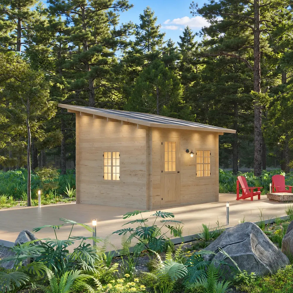 Angled view of the Multi Cube Versa 100 cabin with a slanted roof, wooden door, two glowing windows, deck, and forest landscaping.