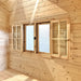  Multi Cube Versa 100 window unit with two outward-opening wooden shutters surrounding central glazed panels on a sunlit pine wall.