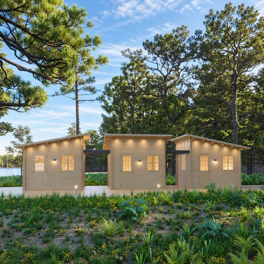 Three Multi Cube Versa 100 modules connected side by side in a wooded retreat with warmly illuminated doors and windows.