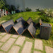 Multiple Jackery SolarSaga 500X Solar Panel units are connected to a Jackery portable power station on a lawn for outdoor solar charging