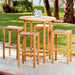Multiple stools, including Westminster Teak Somerset Backless Bar Stool, surround a tall round outdoor table on a stone patio with trees and grass nearby