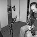 Musician playing an acoustic guitar beside a microphone and GIK Acoustics ScreenPanel Vocal Screen used for sound isolation
