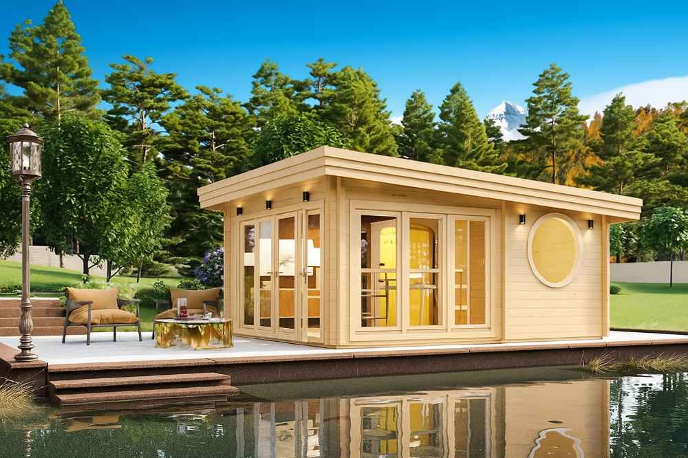 Nestled beside a pond with mountain views, the GardenHouse24 USA Sauna Tanonka 70 Garden Room glows warmly from within its stylish, circular-windowed frame