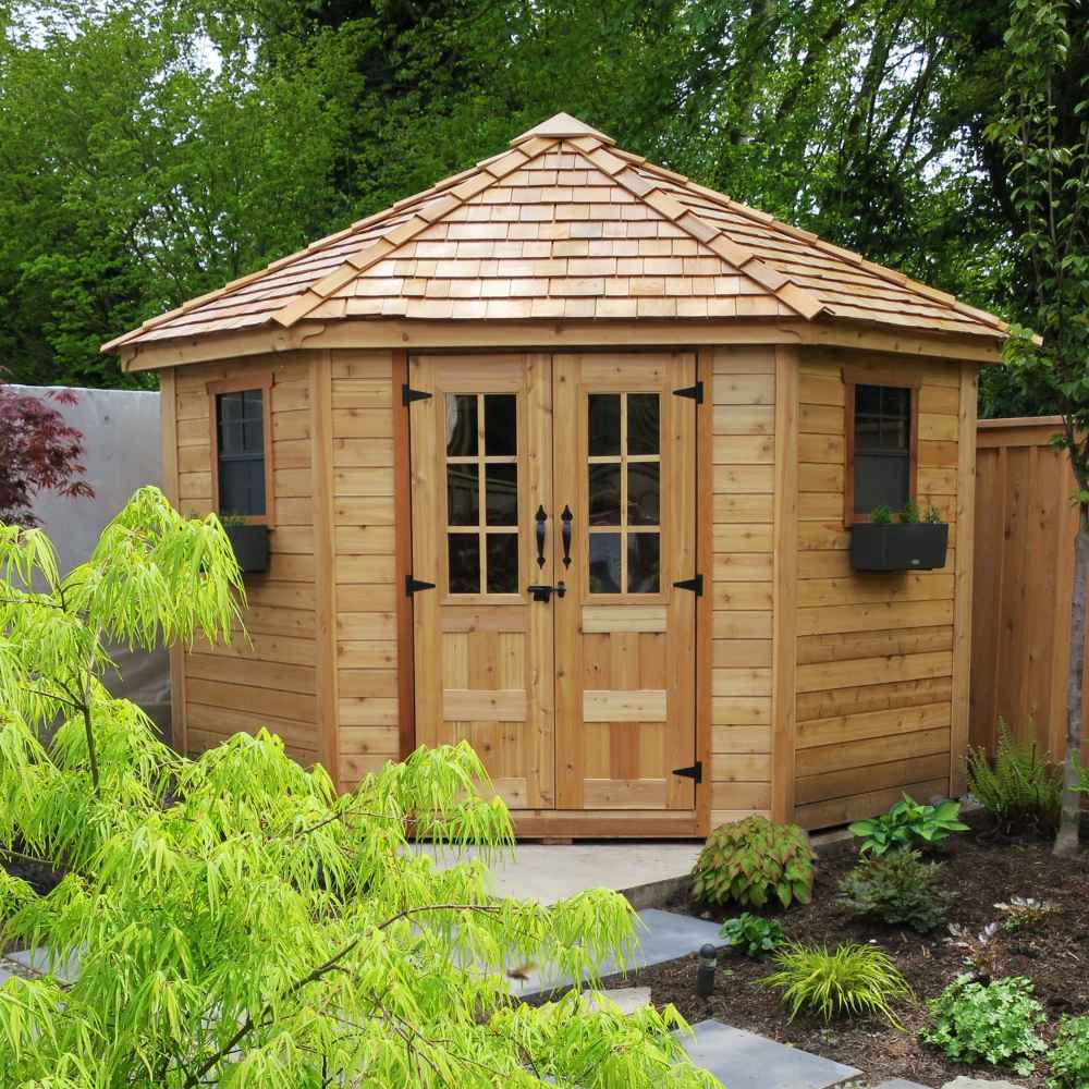 Nestled among lush greenery, the Outdoor Living Today 9×9 Penthouse Garden Shed adds charm to a landscaped backyard garden