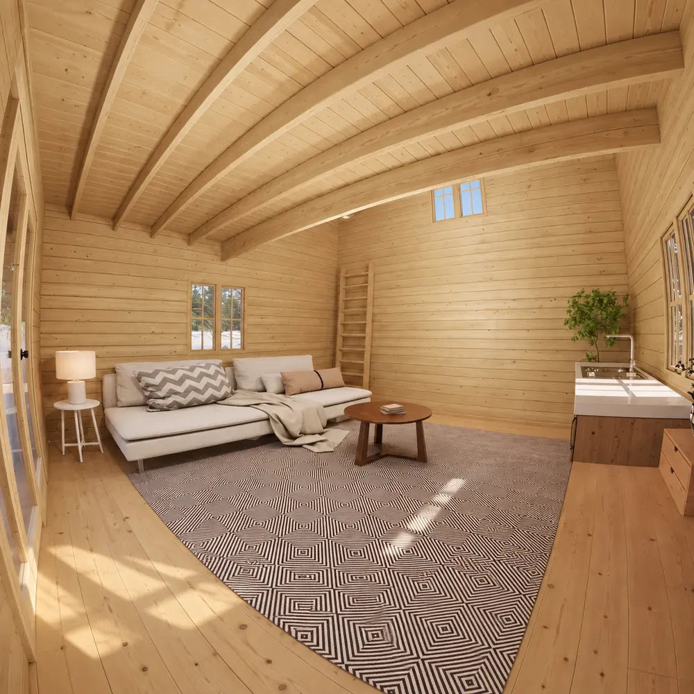 Northwood Grand DD interior with a white sofa, large geometric rug, round coffee table, kitchenette and wooden ladder leading to the loft.