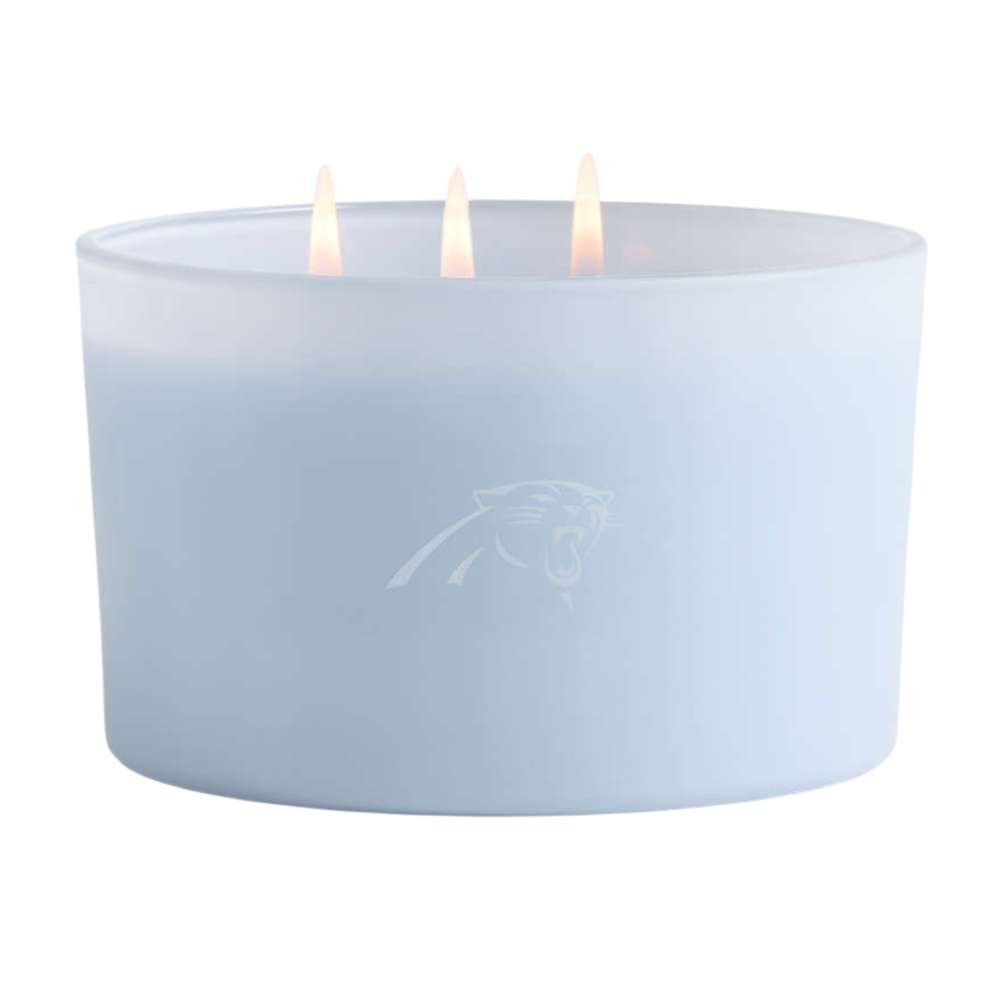 Ocean light blue three-wick Crate & Barrel Monochrome Scented Candle featuring a subtle Carolina Panthers logo on the wide glass vessel