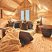 Cozy Ontario Grand Loft 107 SD lounge nook with layered pillows, warm table lamps, a central window, and natural pine walls.