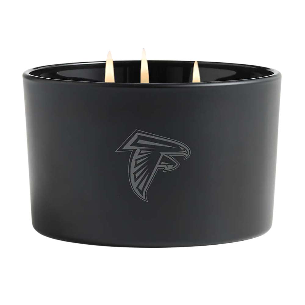 Onyx black three-wick Crate & Barrel Monochrome Scented Candle featuring an Atlanta Falcons logo on the wide glass vessel