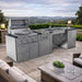 Open grill view of the Sunstone Summit 10ft Outdoor Kitchen Island Package showing cooking grates, sink, and cabinets in an outdoor setting