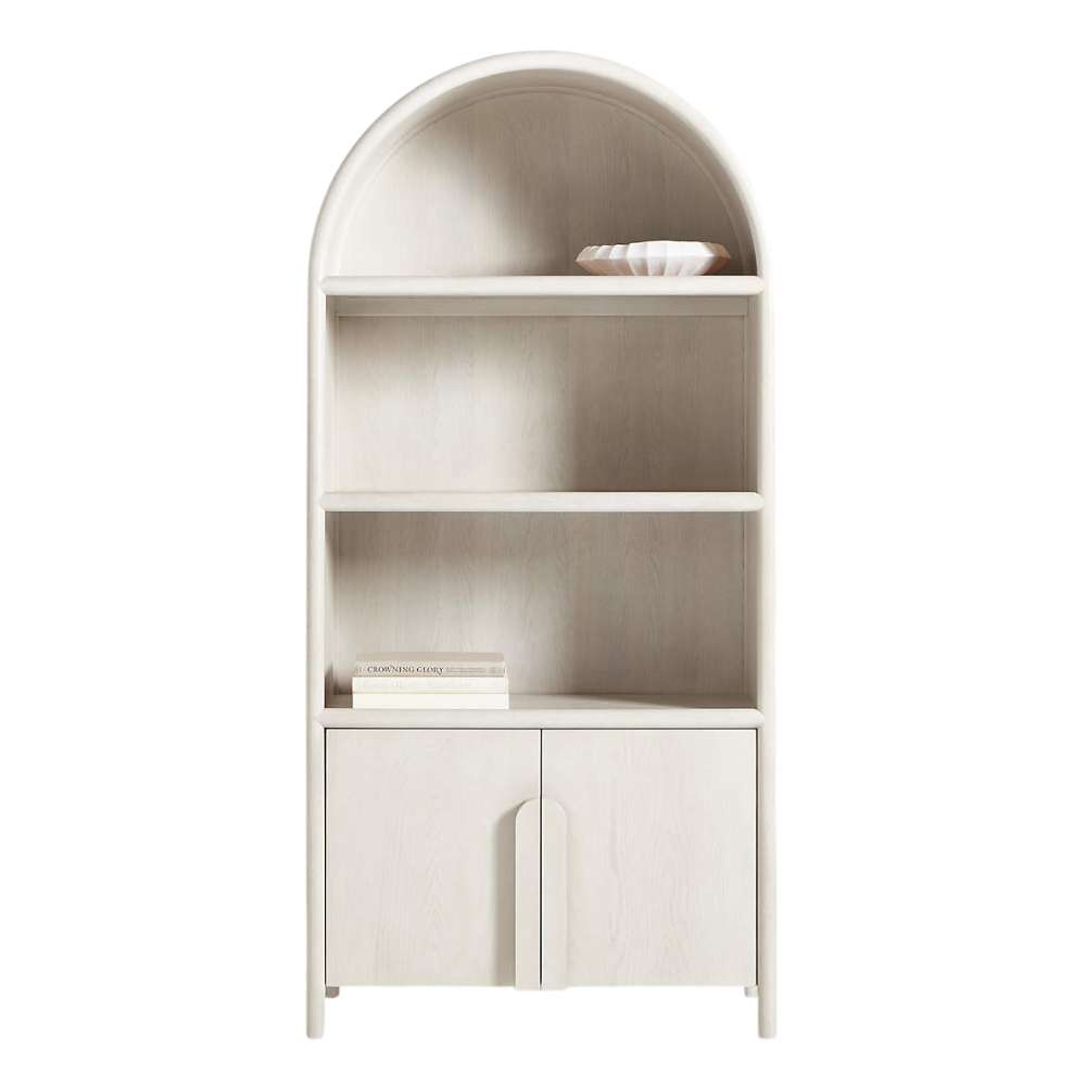 Open shelves of Crate & Barrel Annie 38" Whitewashed Wood Storage Bookcase with Shelves styled with books and decorative accents