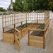 Outdoor Living Today 12ft Raised Garden Bed Climbing Support surrounds a raised garden bed filled with soil and young plants, with mesh sides and lattice panels above