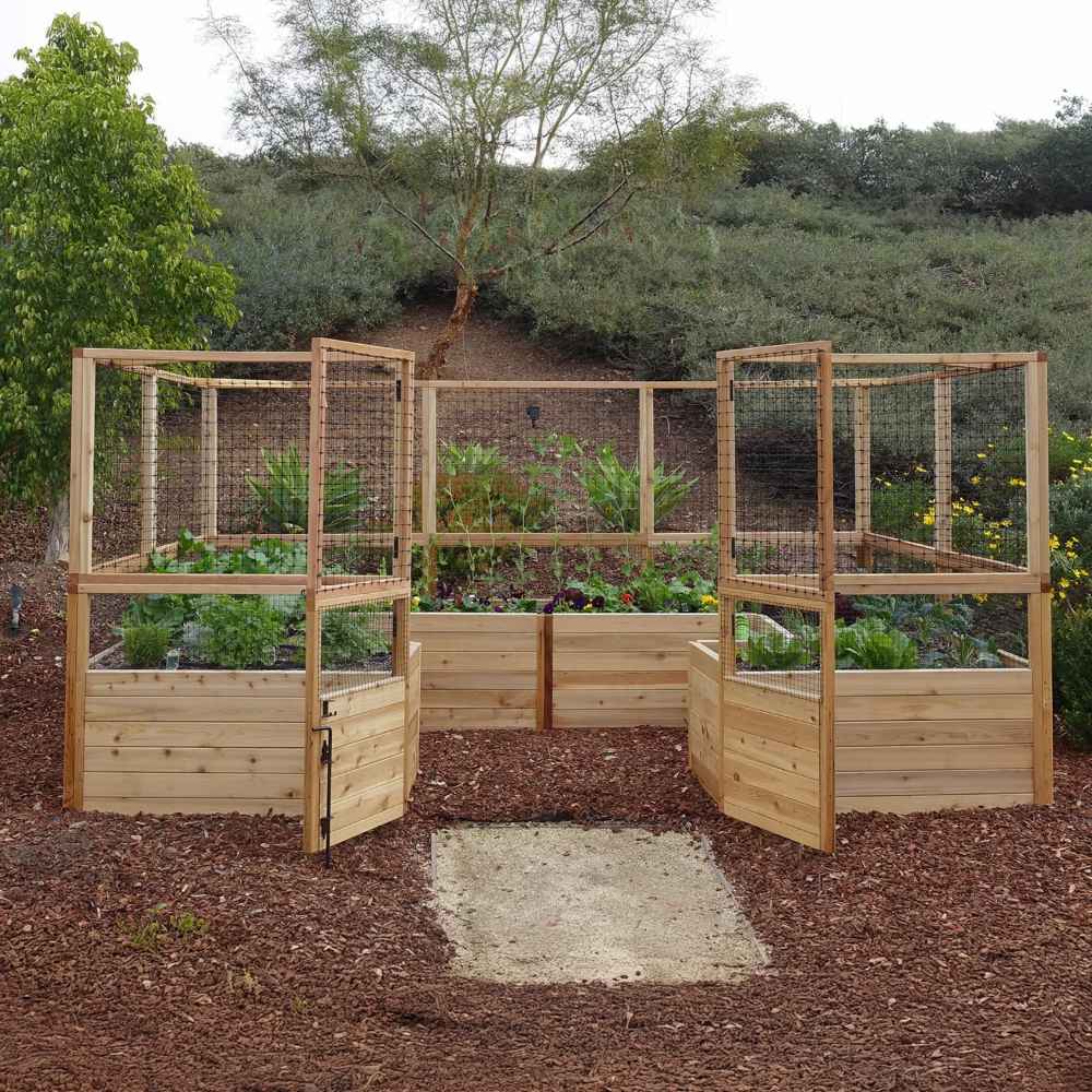 Outdoor Living Today 12×8 Raised Garden Bed is shown with both gates wide open and protective mesh panels lifted up in a lush outdoor garden