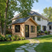 Outdoor Living Today 12×8 Saltbox Studio Outdoor Office appears as a cedar shed placed in a landscaped backyard beside a modern home
